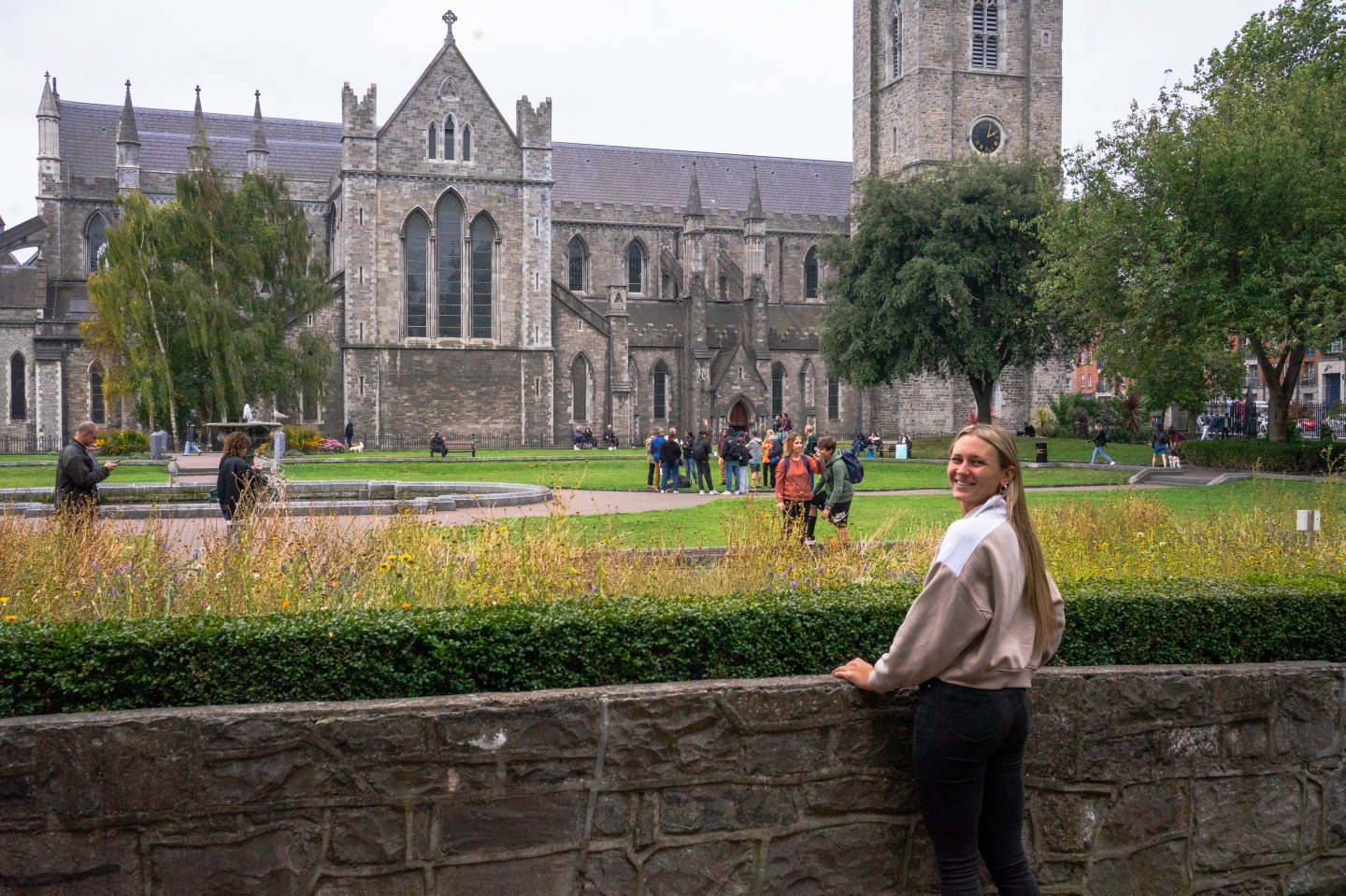 A woman smiling and looking at St Patricks Cathedral