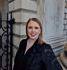 Image of Aoife on Trinity campus, wearing a black dress