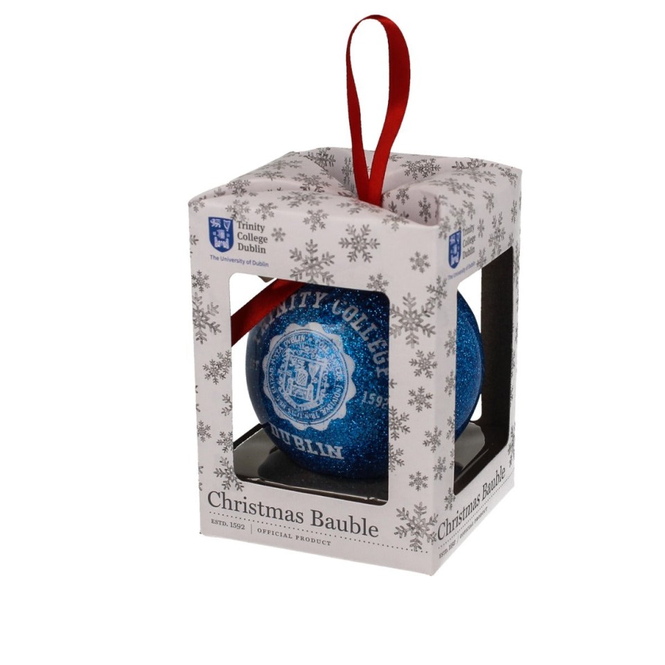 Glittering Trinity College Dublin Christmas bauble featuring the University crest hanging on a decorated tree.