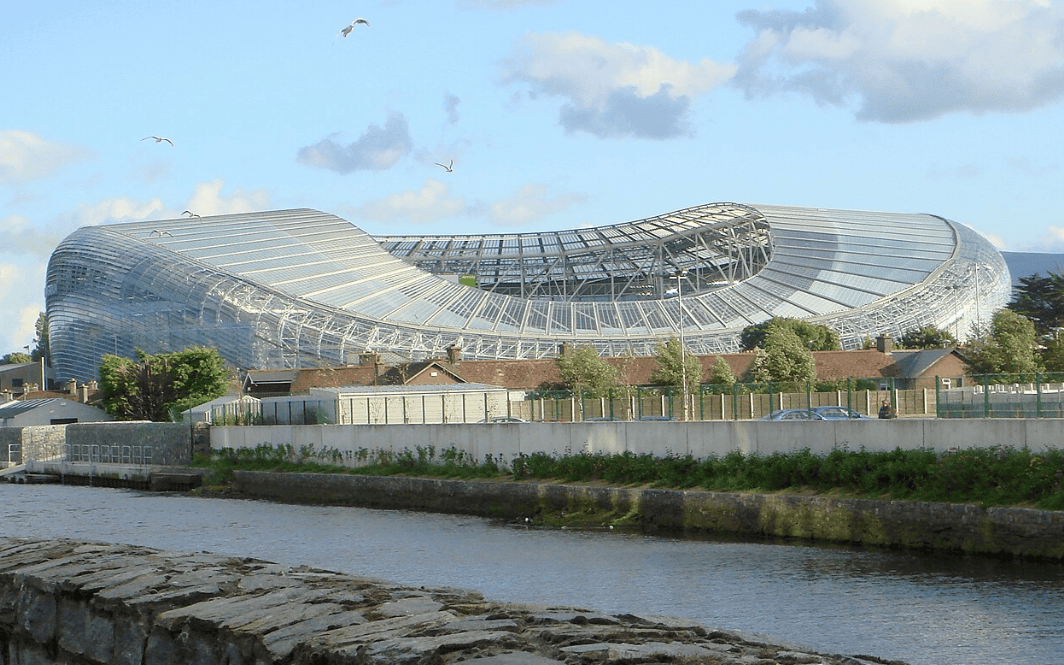 A large stadium featuring a distinctive curved roof, showcasing modern architectural design.